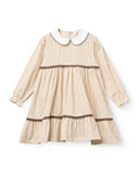Flat lay of sand striped dress with white peter pan collar, brown piping and lace trim at waist and tiered hem