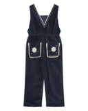 Navy blue overalls with white star patterns on a white background