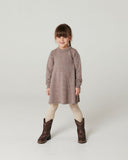 Girl wearing brown melange knit dress with scalloped neckline, cream ribbed tights, and embroidered cowboy boots