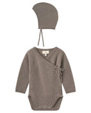 Brown knitted baby bodysuit with matching hat on a white background