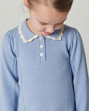 Toddler boy wearing blue denim jacket with corduroy collar over mustard knit sweater, brown ribbed beanie, studio backdrop