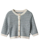 Baby wearing blue grey melange knit cardigan with cream trim, close up smiling