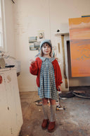 Blue and grey check baby dress with ruffle collar, lifestyle photo