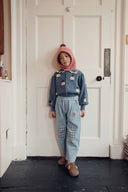 Dusty blue jacquard baby cardigan with sheep pattern and ruffle collar, lifestyle photo