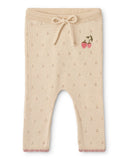 Cream pointelle knit baby pants with drawstring waist, strawberry embroidery and pink scalloped cuffs, flat lay
