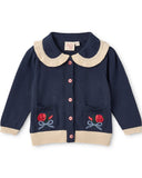 Navy blue cardigan with beige collar and rose embroidery on a white background