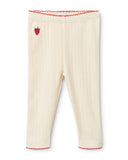 Cream pointelle knit baby leggings with strawberry embroidery and red scalloped trim, flat lay on white background