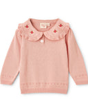Pink sweater with a ruffled collar on a white background