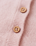 Close up of wooden buttons on light pink cashmere romper placket