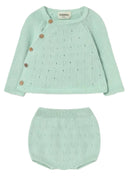 Light green baby outfit with cardigan and bloomers on a white background