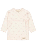 A baby long-sleeve wrap top in a very pale pink or cream color, featuring a delicate all-over floral print and a side tie closure. The brand 'Marmar' is visible on the inner neck label and a small patch near the bottom hem.