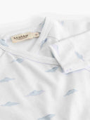 Close up of wrap bodysuit collar and cuff with pale blue cloud print and MarMar Copenhagen tag