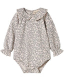 A long-sleeve baby bodysuit with a delicate gray floral print on a warm beige background, featuring a wide Peter Pan collar and ruffled cuffs, laid flat on a white background.