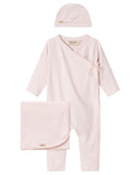 Pale pink newborn gift set with kimono style wrap romper, hat, and blanket, flat lay on white background