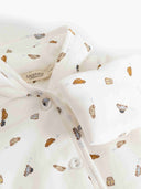 Close up of cream car print jumpsuit fabric with MarMar Copenhagen tag and button detail