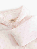 Close up of pink floral duvet suit collar with MarMar Copenhagen label and button placket
