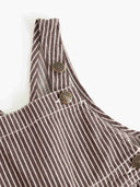 Close up of striped overalls shoulder strap with MarMar Jeans snap buttons
