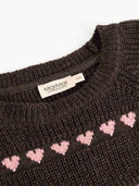 Close up of MarMar Copenhagen label on dark brown knit sweater with pink heart stripe pattern