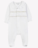 Baby pyjama sleepsuit with ruffled collar, white cotton with gold embroidered trim, flat lay
