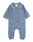 Denim blue cashmere romper with off white collar trim, wooden buttons, and hip pockets, flat lay