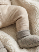 Close up of baby wearing khaki melange fleece booties with grey ribbed cuffs