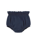 A pair of navy blue baby bloomers with a ruffled waistband, photographed flat against a solid white background.