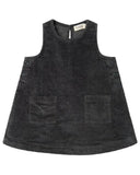 A sleeveless black corduroy pinafore dress with two front patch pockets and button details on the sides, shown flat on a white background.