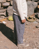 Side view of child outdoors wearing grey pinstripe trousers with cargo pocket and drawstring waist